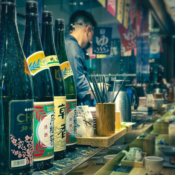Sake bottles on a wooden shelf